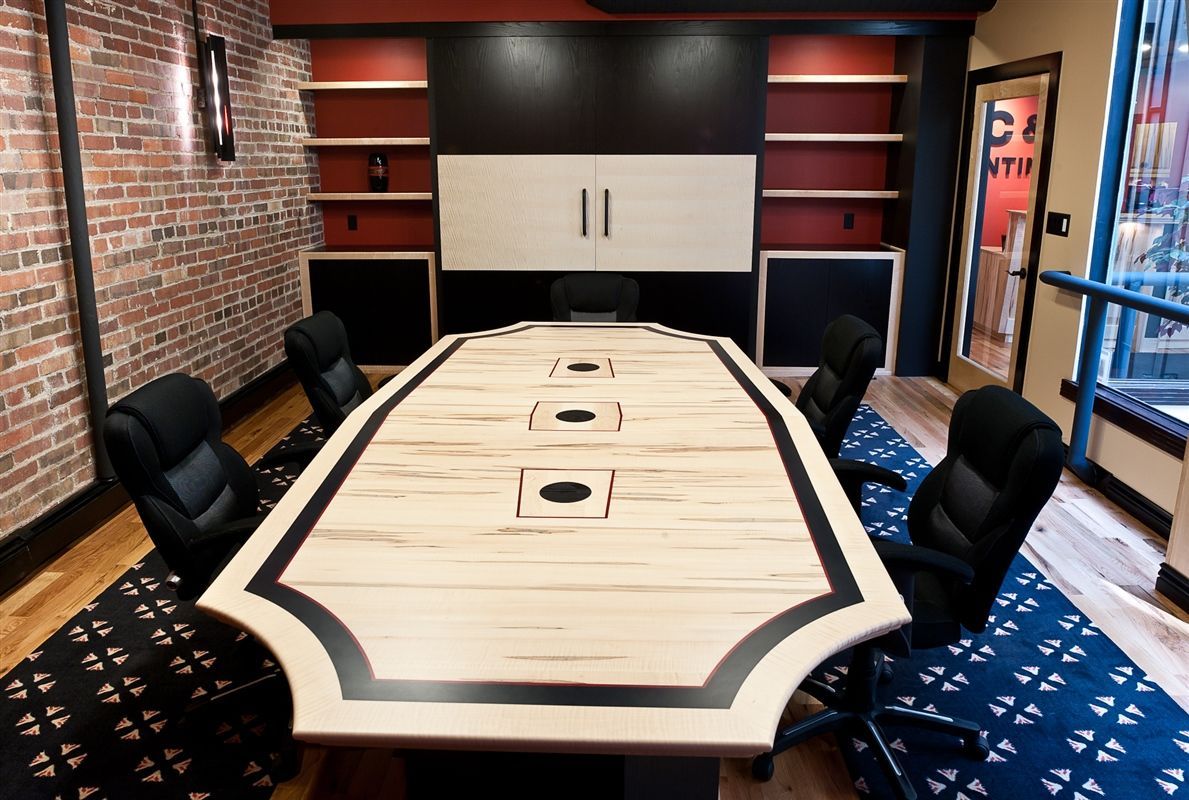 A conference room with a long wooden table and chairs