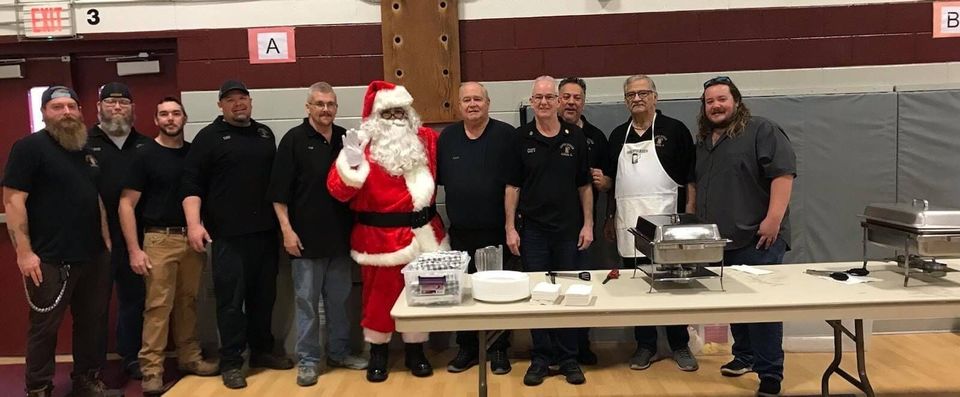 A group of men are posing for a picture with santa claus.