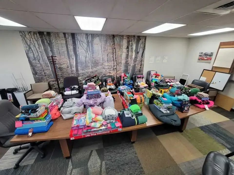 A room filled with lots of toys on tables and chairs.