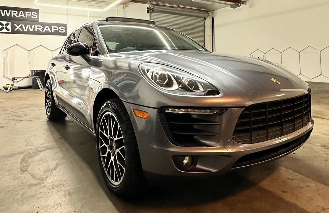 Porsche SUV with premium ceramic coating by XWRAPS Los Angeles - mirror-like silver finish, LED headlights, and custom alloy wheels showcasing superior paint protection