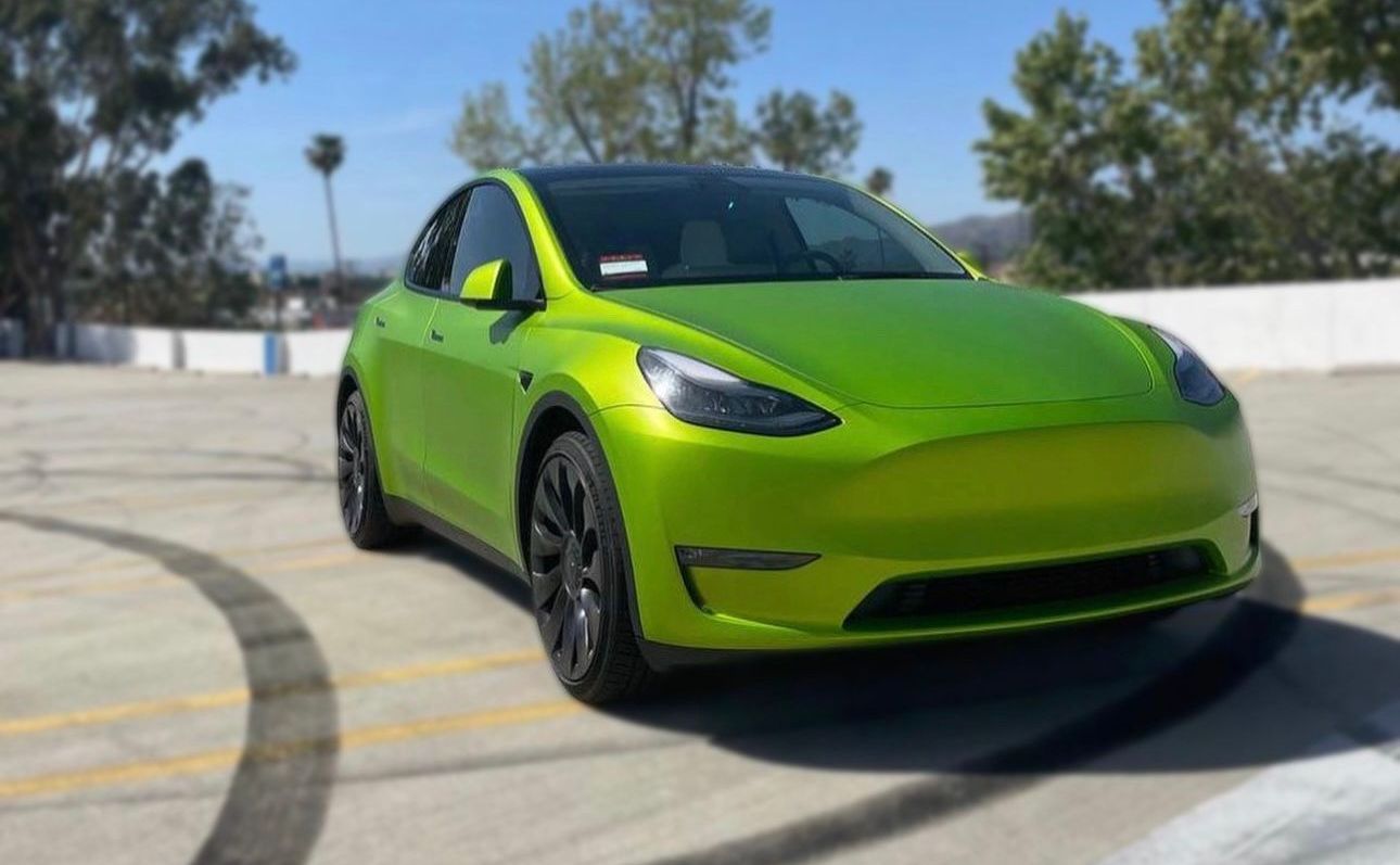 Tesla Model Y with vibrant green ceramic coating by XWRAPS Los Angeles - glossy finish under California sun