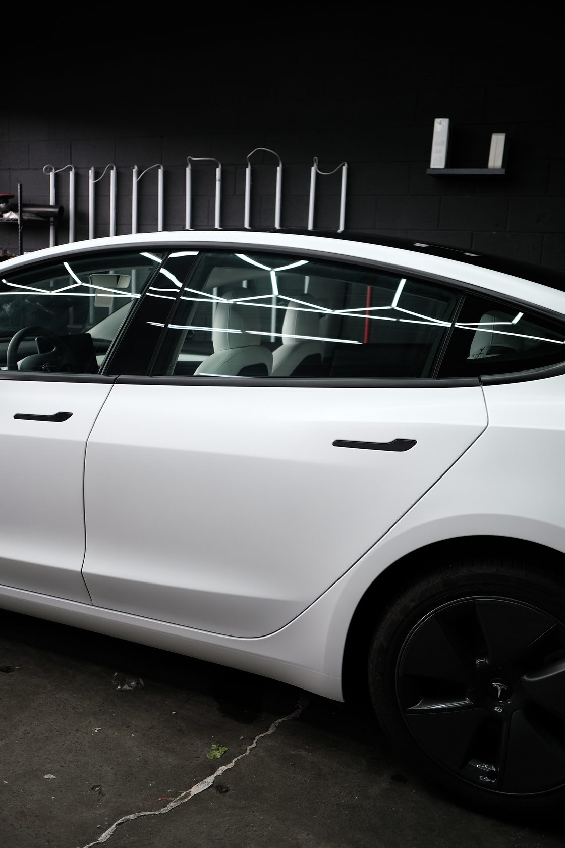 Tesla with ceramic coating wrap by XWRAPS Los Angeles - sleek white finish and reflective windows