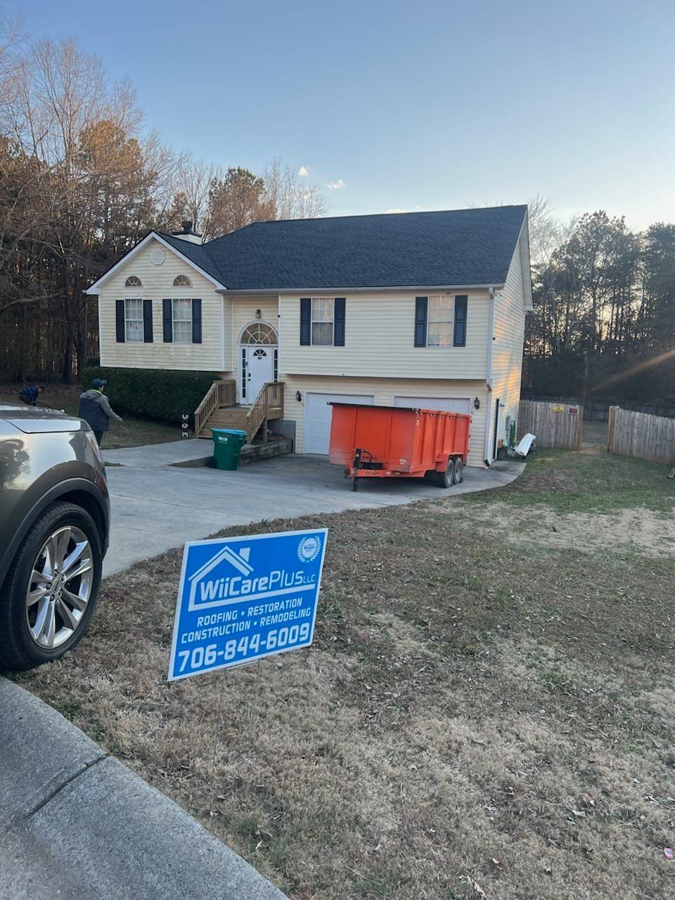 Gray asphalt shingle roof with multiple planes, a ridge vent, and an overall weathered appearance.