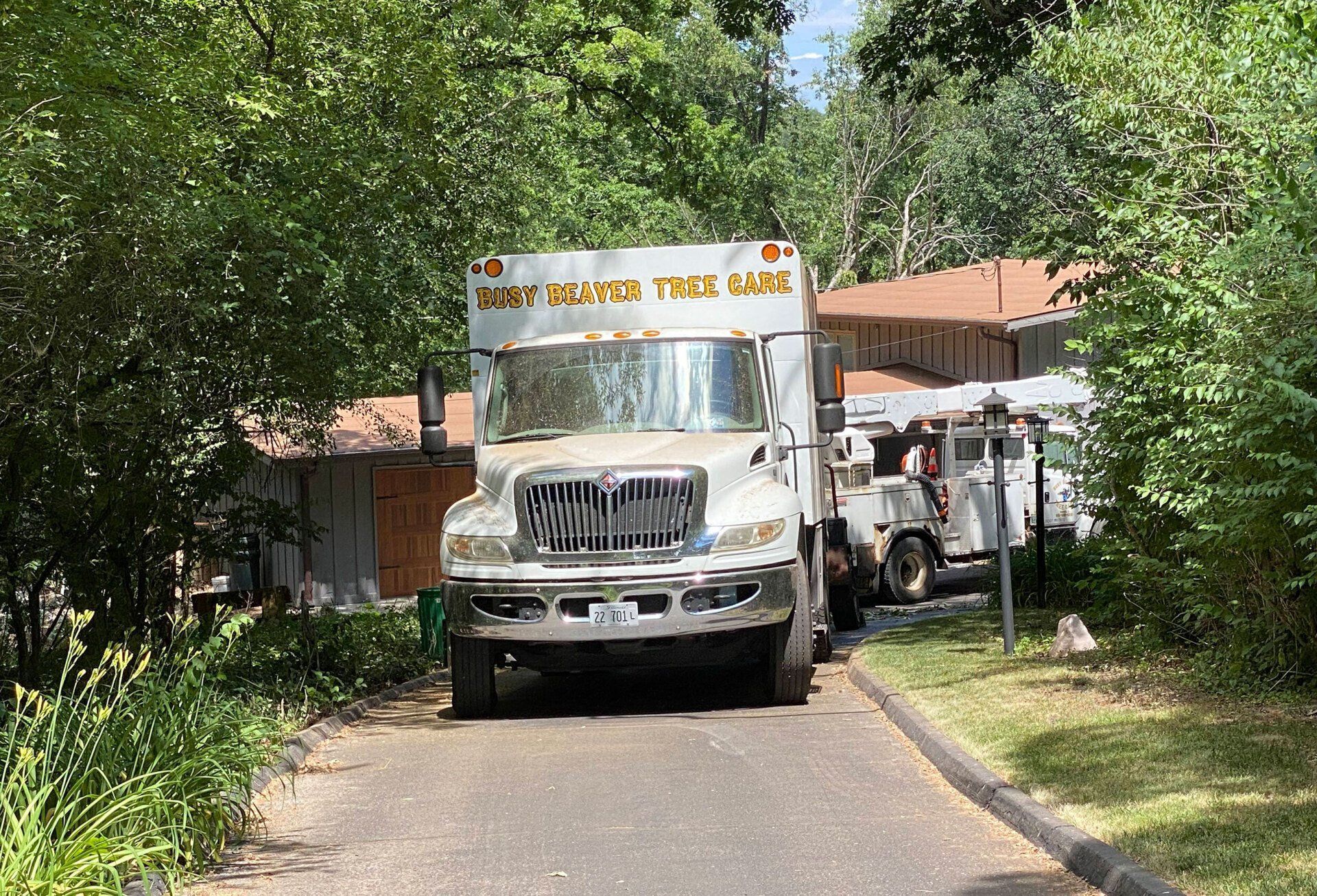 A white truck is parked in front of a house.