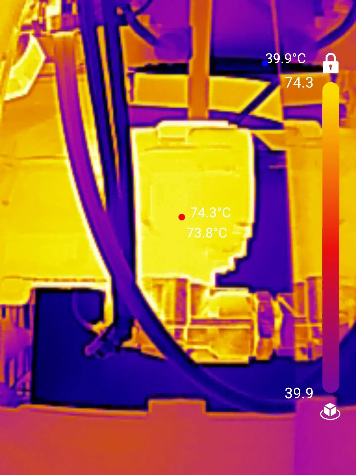 Thermal image of machinery showing a hot spot at 74.3°C, indicated by yellow color.