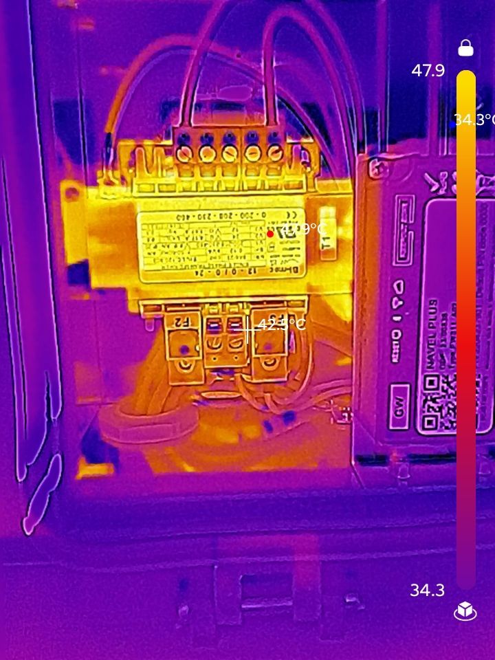 Thermal image of electrical components, highlighting a hot spot in yellow, temperature range 34.3° to 143.0°F.
