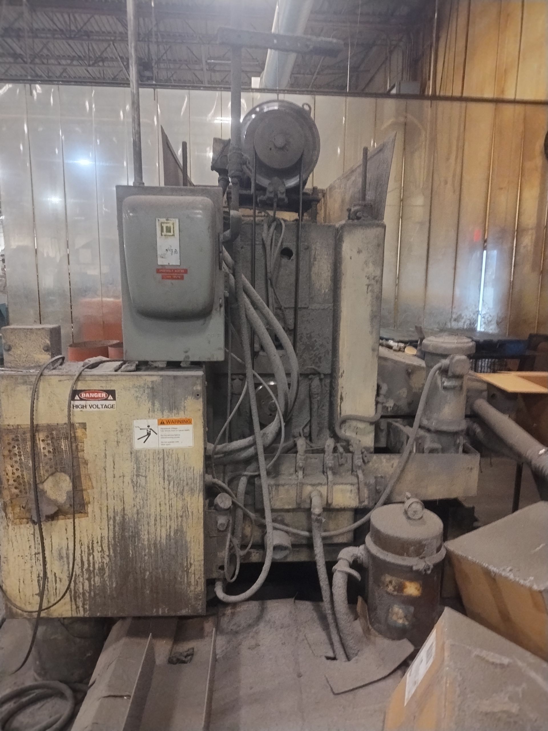 Industrial machine in a workshop, with electrical components and wiring.