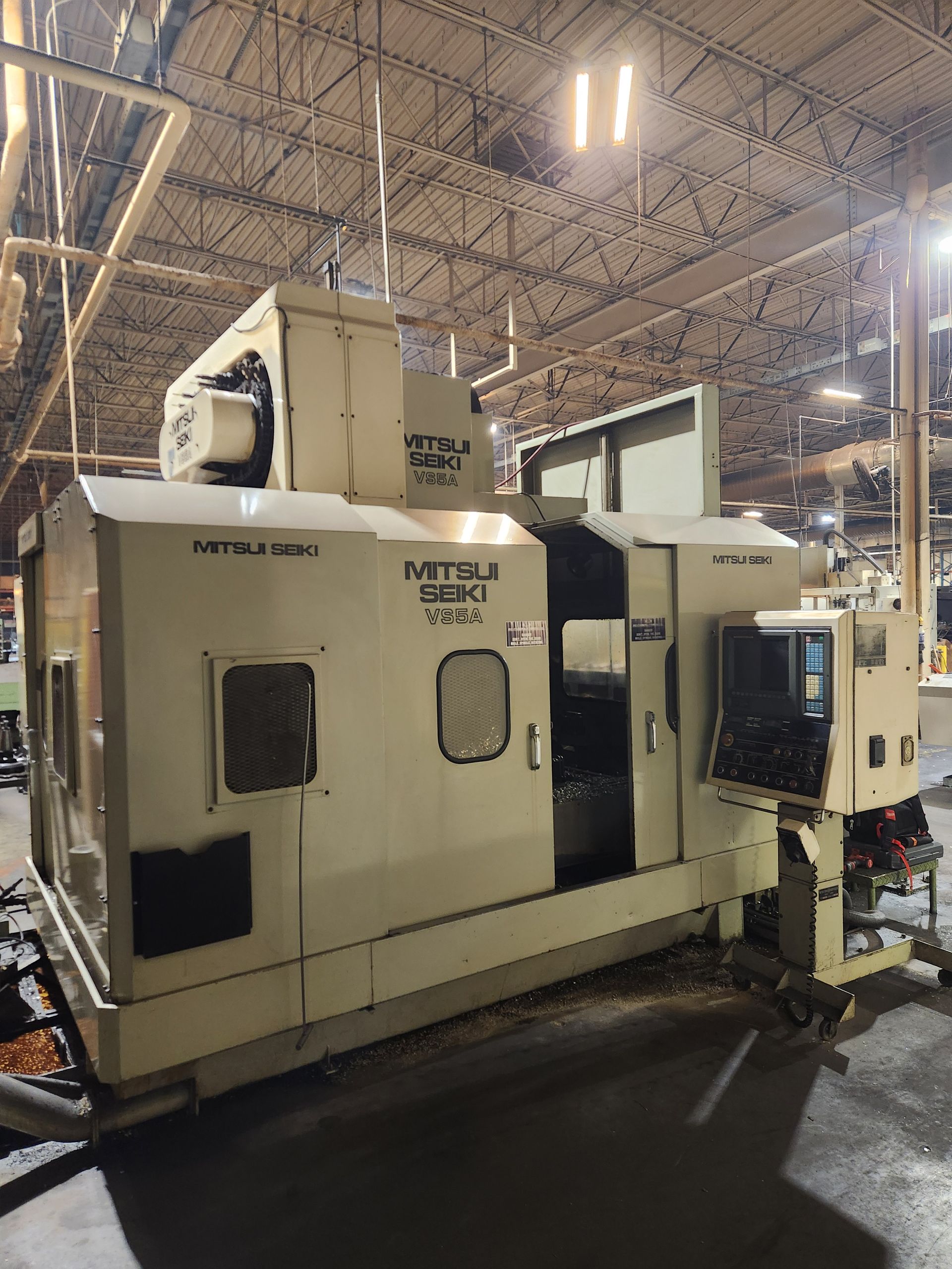 Large beige Mitsubishi HMK63 horizontal machining center in a factory setting.