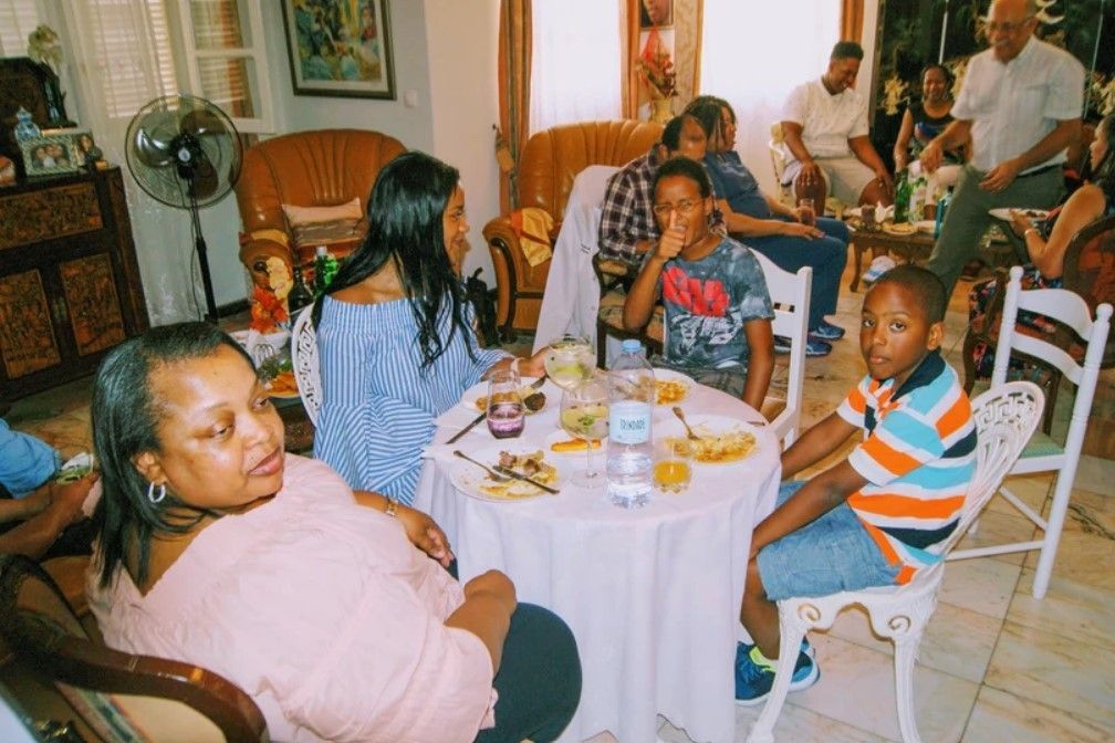 A group of people are sitting around a table eating food