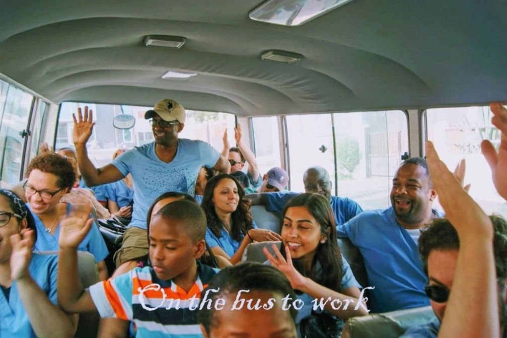 A group of people on a bus with the words on the bus to work