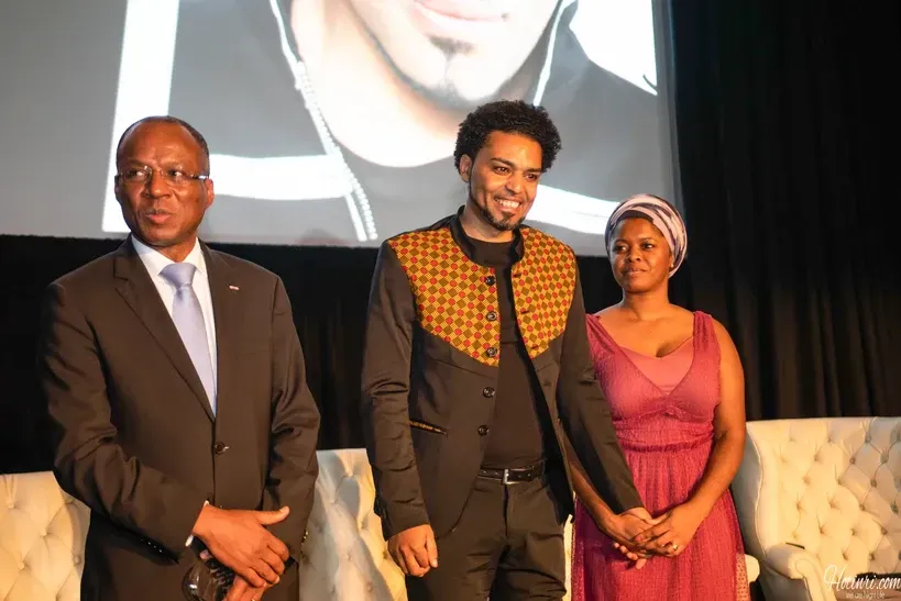 A group of people standing next to each other on a stage.