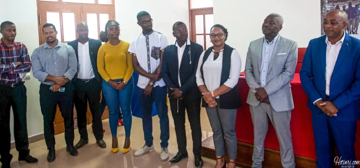 A group of people standing next to each other in a room.