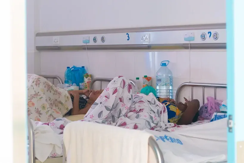 A woman is laying in a hospital bed.