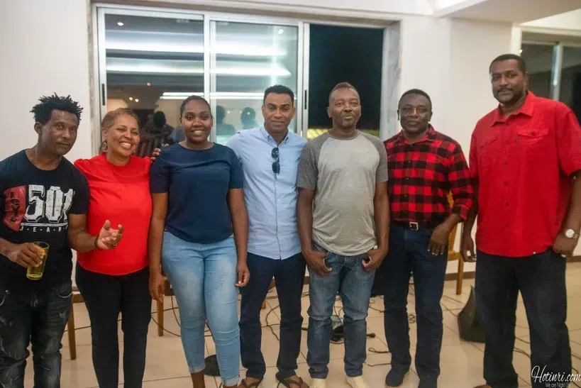 A group of people are posing for a picture together in a room.