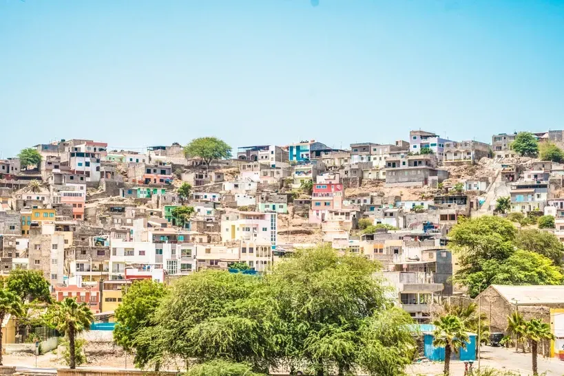 An aerial view of a slum area with lots of buildings and trees.