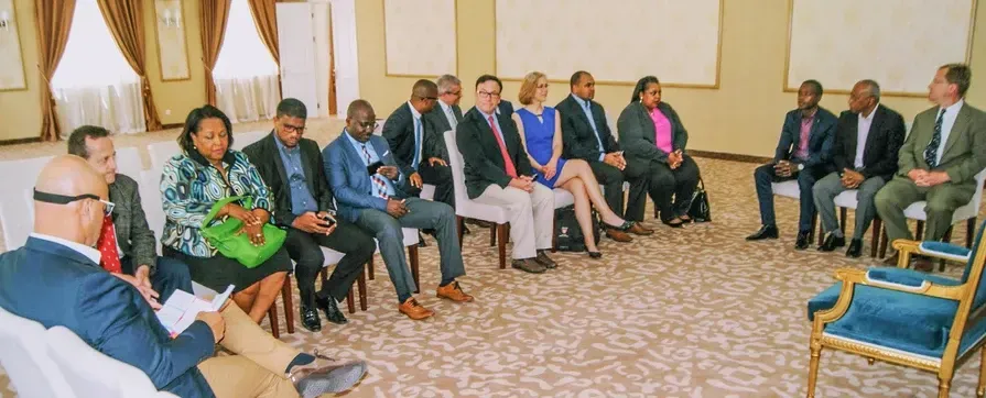 A group of people are sitting in a circle in a room.