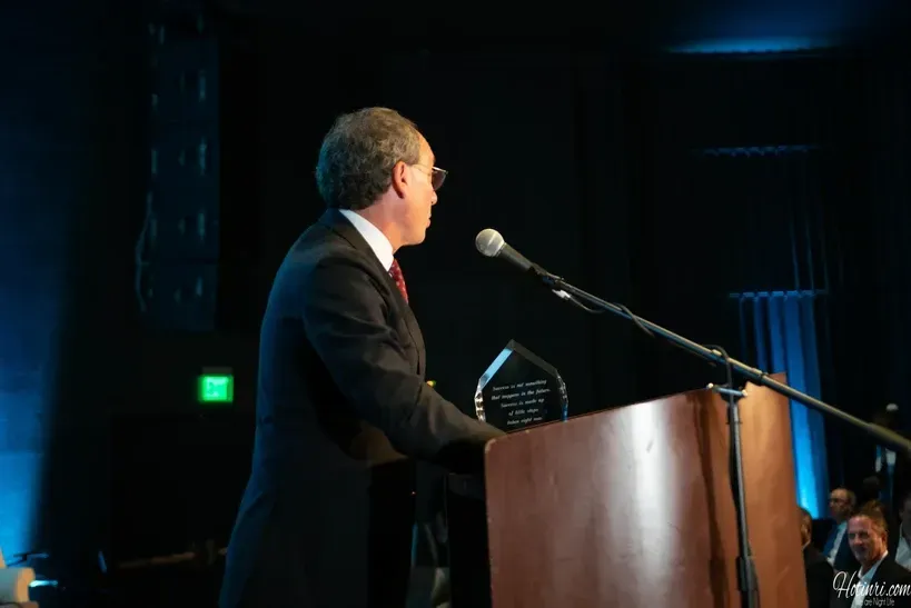 A man stands at a podium giving a speech