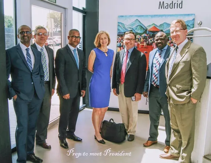A group of people standing in front of a sign that says madrid