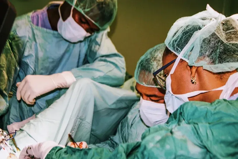 A group of surgeons are performing surgery on a patient