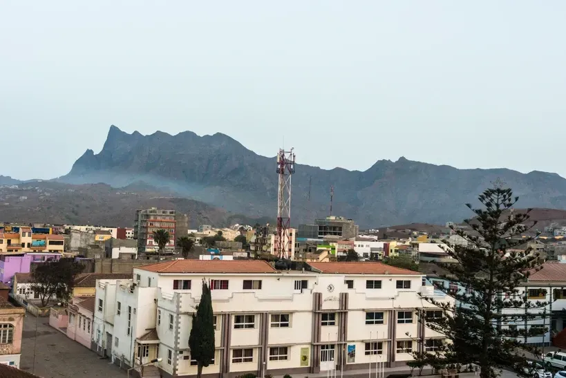 An aerial view of a city with mountains in the background
