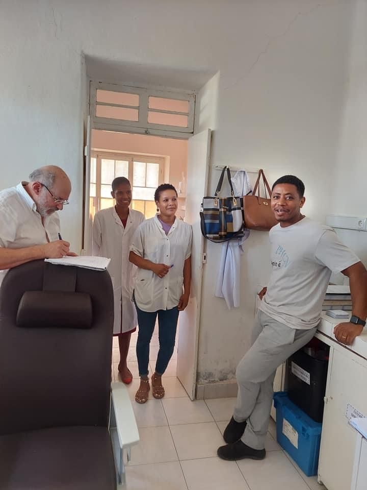 A group of people are standing in a room.
