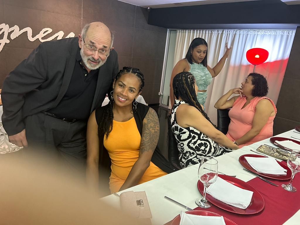 A group of people are posing for a picture at a table.