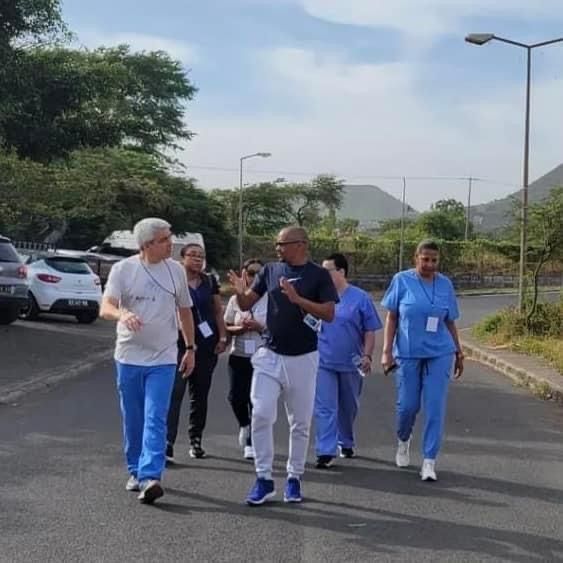 A group of people are walking down a street.