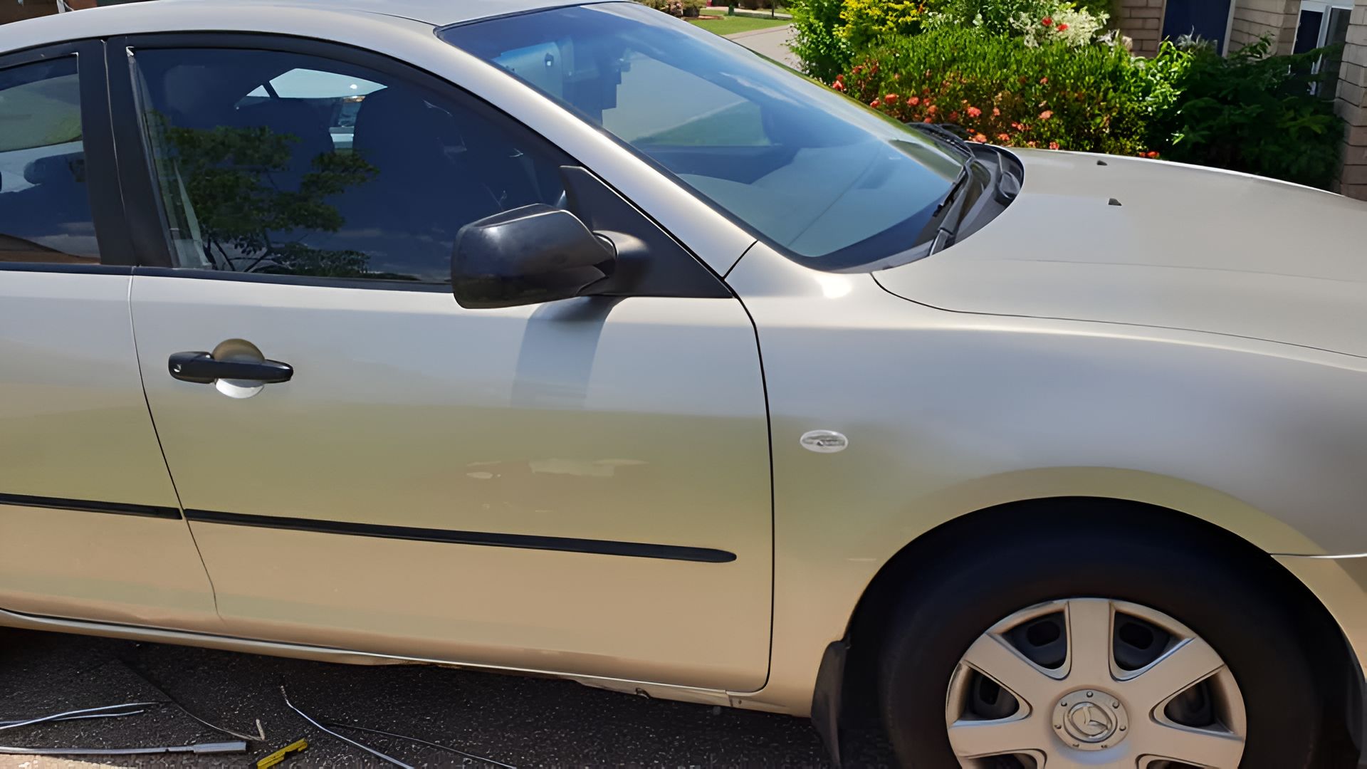 A Silver Car is Parked in a Driveway in Front of a House — Dek-A-Dent Townsville In Wulguru, QLD