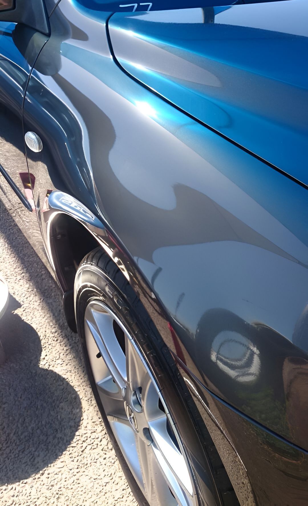 A Blue Car is Parked on the Side of the Road — Dek-A-Dent Townsville In Wulguru, QLD