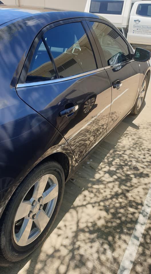 A Black Car is Parked in a Parking Lot — Dek-A-Dent Townsville In Wulguru, QLD