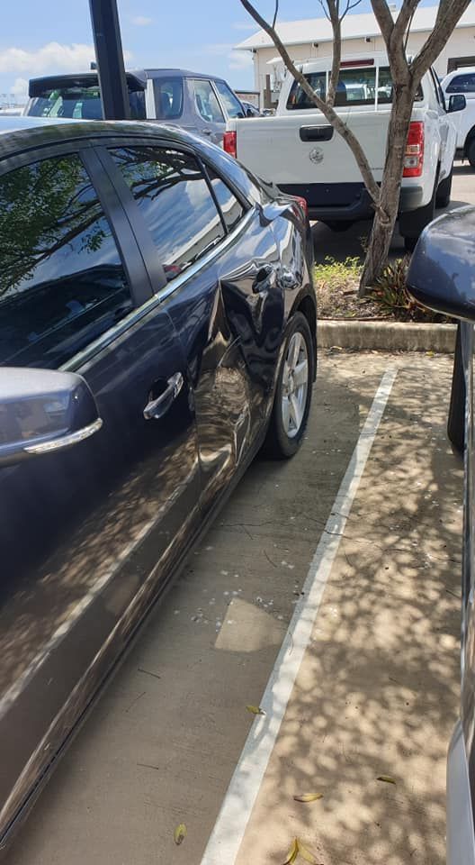 A Car With a Damaged Side is Parked in a Parking Lot — Dek-A-Dent Townsville In Wulguru, QLD