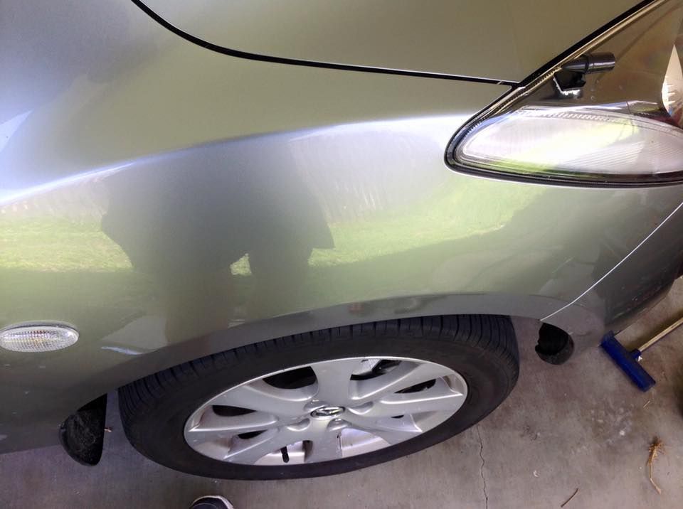 A Silver Car is Parked in a Garage With the Hood Up — Dek-A-Dent Townsville In Wulguru, QLD