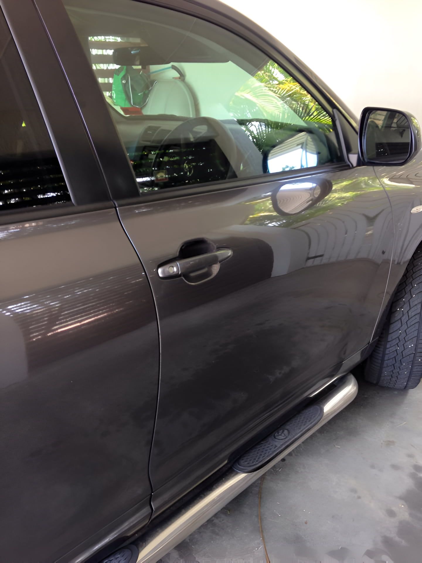 A Car is Parked in a Garage With the Door Open — Dek-A-Dent Townsville In Wulguru, QLD