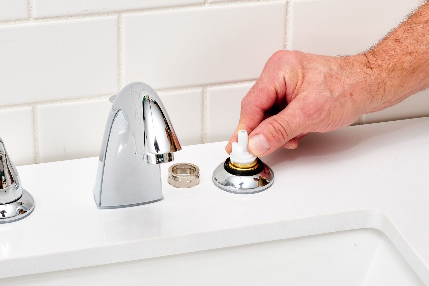 A kitchen sink with a garbage disposal underneath it.