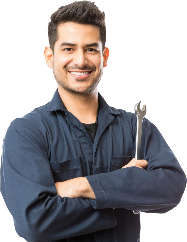 A man in a blue jumpsuit is holding a wrench and smiling.