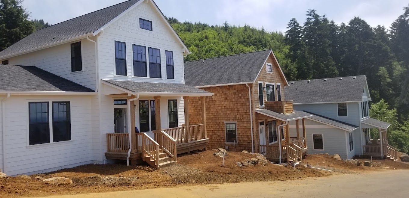 A row of houses are being built in a residential area.
