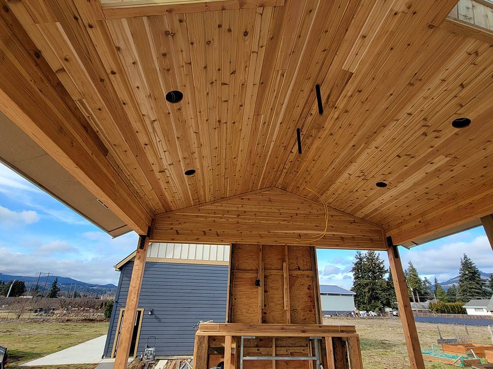 The ceiling of a wooden structure is being built.