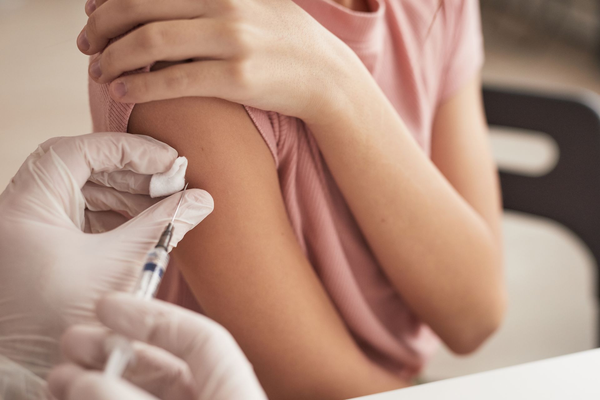 Child receiving an injection in their arm