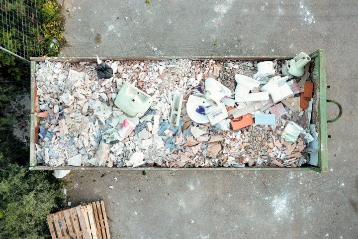 An aerial view of a dumpster filled with trash