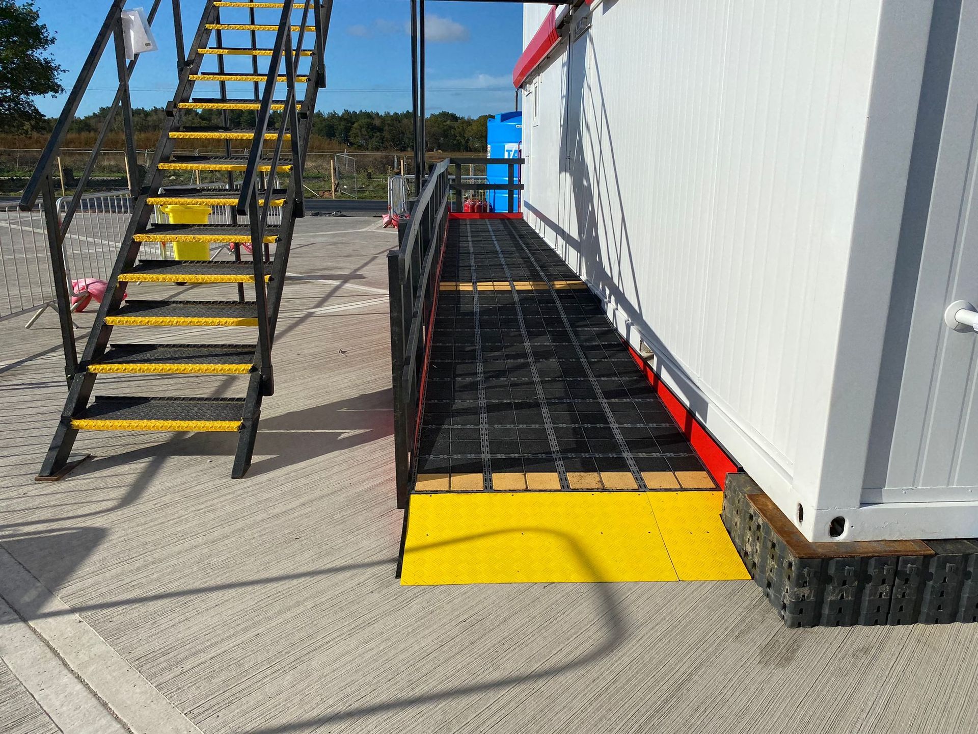 Light-colored wood-grain flooring, angled view, showing planks with variations in wood patterns.