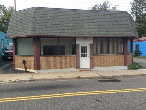 Freestanding Warehouse  With White Door — Clifton, NJ — Evergreen Commercial Real Estate Brokers Inc
