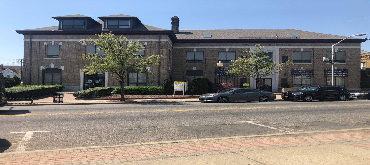 A Large Building with Cars Parked in Front — Clifton, NJ — Evergreen Commercial Real Estate Brokers Inc