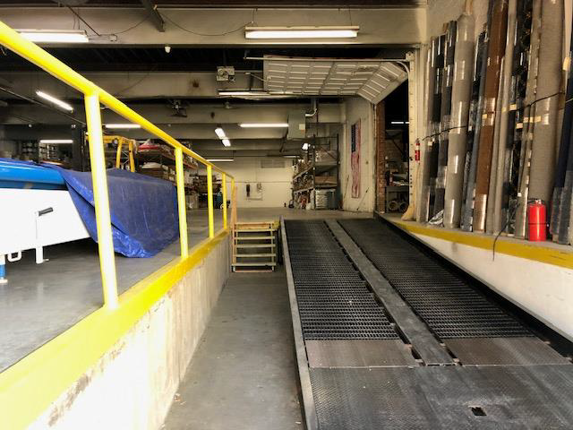 A warehouse with a ramp and stairs in it