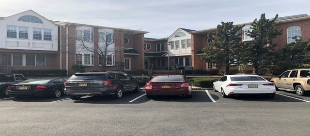 Red Vehicle Parked On Office Building — Clifton, NJ — Evergreen Commercial Real Estate Brokers Inc