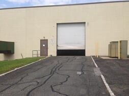 Warehouse With Slightly Opened Door — Clifton, NJ — Evergreen Commercial Real Estate Brokers Inc
