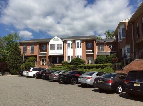 Different Cars Parked On Condominium — Clifton, NJ — Evergreen Commercial Real Estate Brokers Inc