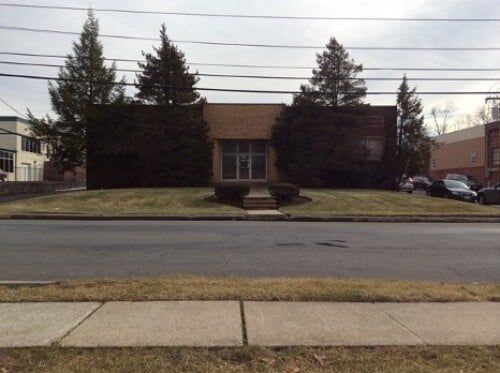 Two Pine Trees Infront Of Warehouse — Clifton, NJ — Evergreen Commercial Real Estate Brokers Inc