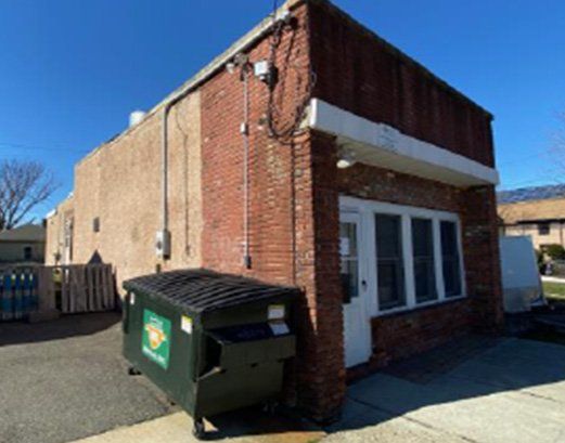 Dumpster Near Commercial Property — Clifton, NJ — Evergreen Commercial Real Estate Brokers Inc