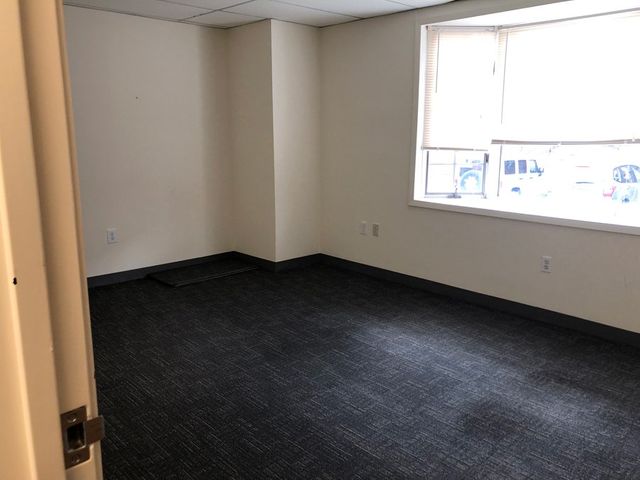 Empty Carpeted Room With Huge Windows — Clifton, NJ — Evergreen Commercial Real Estate Brokers Inc