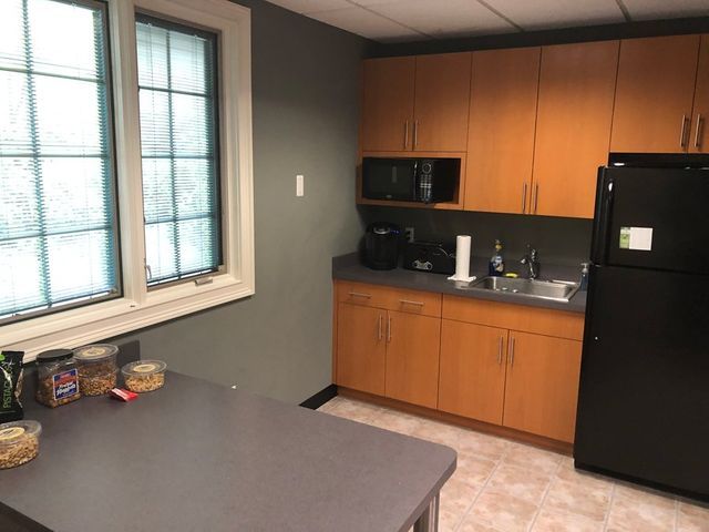 Office Kitchen With Wooden Cabinets — Clifton, NJ — Evergreen Commercial Real Estate Brokers Inc